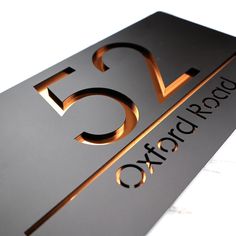 a close up of a metal sign on a white surface with the words 5g