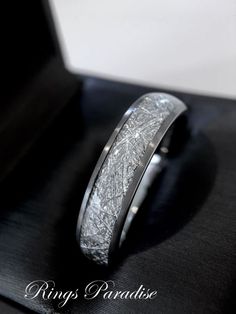 a wedding band that has been made to look like it is in white gold and silver