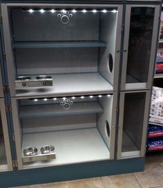 an empty display case in a store with lights on the front and side shelves behind it