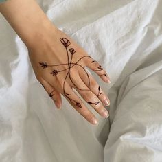 a woman's hand with a tattoo on it