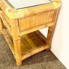 a wooden table with glass top on carpeted floor