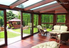 a room with wooden floors and glass walls