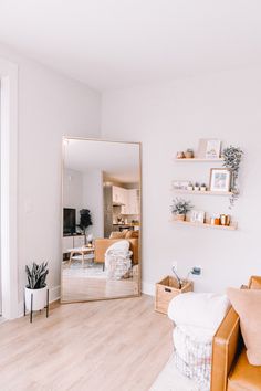 a living room filled with furniture and a large mirror