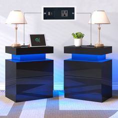 two black and blue tables with lamps on them