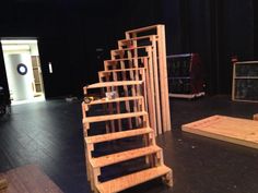 the stage is set up for an upcoming play with wooden steps and crates stacked on top of each other