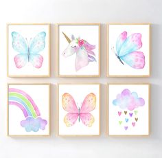 four watercolor paintings of unicorns, butterflies and hearts on white paper with wooden frames