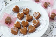 some heart shaped chocolates on a white plate