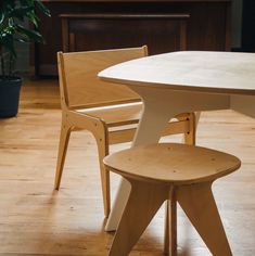 two wooden chairs sitting next to each other on top of a hard wood floored floor