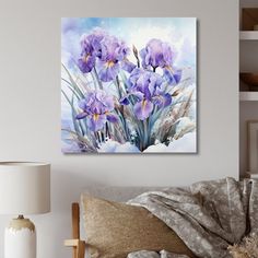 purple irises in watercolor on canvas mounted to wall above couch with white lamp