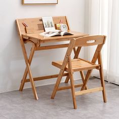 a wooden desk with two chairs next to it