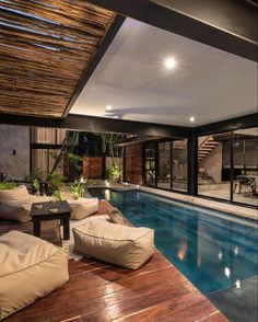 an indoor swimming pool surrounded by wooden floors