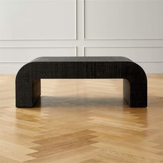 a black bench sitting on top of a hard wood floor