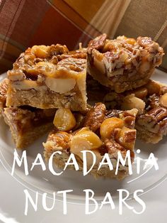 there is a white plate with some food on it and the words macadamia nut bars