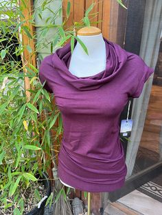 The Kali Cowl is a capped sleeve, hooded tunic. Made from our 200GSM soft bamboo jersey, they are super cute over leggings, they run long to cover the bum with a flattering band to hold their shape, and our signature cowl hood. Stretch Solid Color Cowl Neck Top, Fitted Funnel Neck Top For Loungewear, Casual Stretch Cowl Neck Tops, Casual Cowl Neck Top, Heather Stretch Tops For Fall, Fitted Hooded Top For Layering, Purple Stretch Hooded Top, Cowl Hood, Hooded Tunic