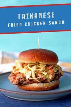 a fried chicken sandwhich on a blue plate