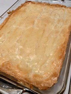 an uncooked casserole in a glass dish on top of a stove