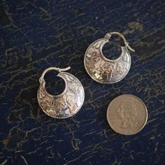 These very pretty, silver cast earrings are from Taxco, Mexico. They are 3-dimensional or "puffy" rather than being flat. Made of .925 silver. This is a substantial earring but light-weight. Lovely! Arracada earrings naturally sit slightly angled in the earlobe. It's not the hole in your ear! They are supposed to be slightly angled and not exactly perpendicular to your head. For that reason, you may be able to see the back side of the earring when you are looking in the mirror. state of origin: Silver Engraved Hoop Earrings For Gift, Artisan Engraved Drop Earrings, Small Hoop Sterling Silver Pierced Earrings, Sterling Silver Small Hoop Pierced Earrings, Silver Engraved Earrings For Gift, Engraved Silver Earrings As Gift, Nickel Free Sterling Silver Clip-on Earrings, Nickel-free Silver Clip-on Earrings, Unique Silver Nickel-free Plug Earrings