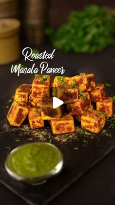 roasted masala paneer served with green chutneys and sauce on a black platter