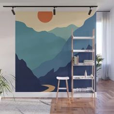 a living room with a wall mural that has mountains and sunsets painted on it