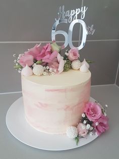 a white cake with pink flowers and the number 60 on top