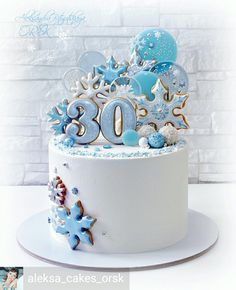 a white cake with blue frosting and decorations