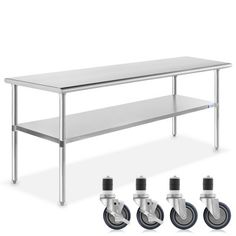 the table is next to four casteors and three wheels on each side, all in stainless steel