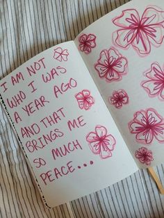 an open notebook with writing on it and flowers drawn on the pages next to each other