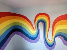 there is a rainbow mural in the corner of this room