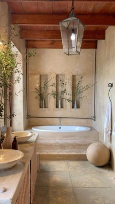 a bathroom with two sinks and a bathtub next to a wall mounted planter