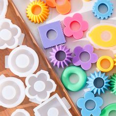 several different shapes and sizes of cookie cutters on a table next to a cutting board