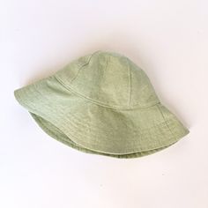 "A mint green linen wide brimmed sun hat that will protect your little beach bum from the sun. The wide brim covers the face, chest and shoulders for maximum sun protection. So let the sun shine! This summer hat will soon become a favorite on your adventures outside. Made from a medium weight mint green linen fabric. Inside liner made of white cotton. This hat has a chin strap with metal snap to help keep the hat on. Brim measures 3.5 inches. HAT SIZES AVAILABLE: 0-3 mos. - 12\" to 14\" head cir Summer Cotton Sun Hat With Flat Brim, Solid Cotton Sun Hat With Flat Brim, Solid Color Cotton Sun Hat With Flat Brim, Green Sun Hat For Beach Season Vacation, Solid Color Cotton Sun Hat For Summer, Cotton Summer Sun Hat, Summer Cotton Sun Hat, Summer Green Sun Hat For Vacation, Green Sun Hat For Beach Vacation