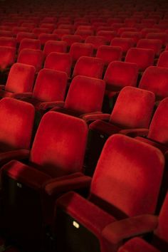 rows of red seats in an empty theater