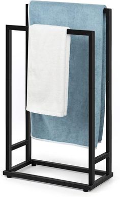 a towel rack with two towels hanging on it's sides and one folded up