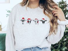 Cow Christmas Sweatshirt The perfect sweatshirt for any season! It's made from a soft, midweight cotton-blend fabric for easy layering when it gets chilly or throw it on alone for comfort. Full of style and comfort, we think this sweatshirt has all the qualities a funny cow lover could ever want. Runs true to size, but size up if you'd like a more oversized fit. Ideal for any situation, a unisex heavy blend crewneck sweatshirt is pure comfort. These cozy sweatshirts are made from polyester and c Christmas Sweatshirt Ideas, Cow Stuff, Sweatshirt Ideas, Christmas Cricut, Cricut Shirts, Cow Christmas, Matching Family Shirts, Christmas Cow