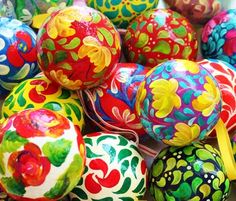 many colorful painted eggs are sitting in a pile together on the table and ready to be used as decorations