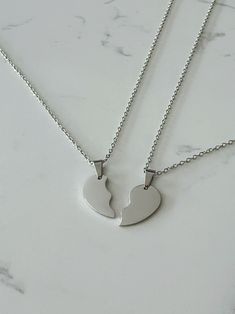 Two half heart necklace set. All materials are stainless steel. Each order comes with 2 necklaces which together will form a whole heart when placed side by side. All necklaces will be 20 inches in length unless requested otherwise.  How to order:  Step 1: Select the colour for your necklace set Heart-shaped Metal Necklaces For Friendship, Heart-shaped Metal Necklace For Friendship, Valentine's Day Double Heart Stainless Steel Necklace, Minimalist Heart Shape Stainless Steel Charm Necklace, Valentine's Day Stainless Steel Double Heart Necklace, Valentine's Day Stainless Steel Necklace, Double Heart Charm Necklace In Stainless Steel, Stainless Steel Heart Pendant Necklace For Best Friend, Silver Double Heart Stainless Steel Necklace