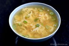 a white bowl filled with soup on top of a table