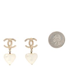 This is an authentic pair of CHANEL Pearl CC Heart Drop Earrings in Gold. These elegant gold tone earrings feature a textured CC logo with a white resin pearl heart pendant. Resin Pearl, Chanel Pearl, Logo With A, Chanel Pearls, Drop Earrings Gold, Pearl Heart, Heart Drop Earrings, Earrings In Gold, Cc Logo