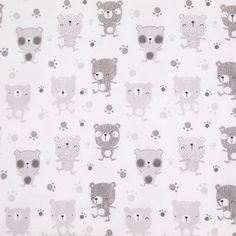 a close up of a white fabric with bears on it