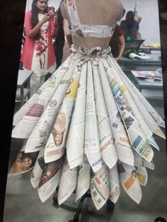 a dress made out of newspapers sitting on top of a table