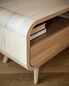 a close up of a wooden table with two books on the top and one drawer open