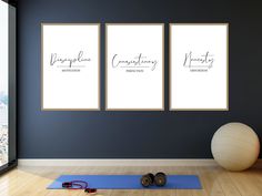 there are three framed pictures on the wall next to a yoga mat and exercise ball