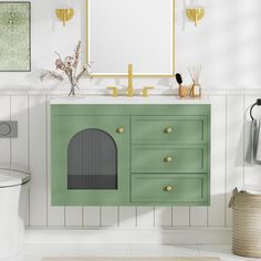 a bathroom with a green cabinet, mirror and rug on the floor in front of it