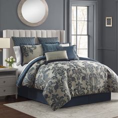 a bed with blue and white comforters in a bedroom