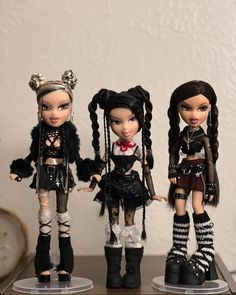 three dolls are standing next to each other