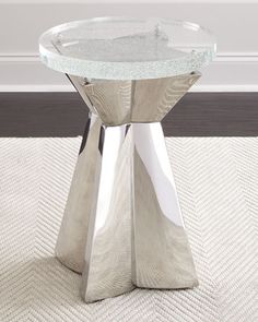 a glass and metal table on carpeted floor