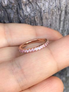 Full Eternity Band Ring with Natural Pink Sapphires. Material: Solid Gold (14K or 18K) Finishing: High Polished/ Shiny Fit: Standard Width: 1.8mm Height: 2mm Setting: U Micro Pave Set Stone: Natural Pink Sapphire Precious Stone Shape & Cut: Round, Diamond Cut Quality: AAA Quantity of Stones: apx 40 (varies by size) Total Carat Weight: 0.80 ct (varies by size) This Ring is Full of Elegance and Beauty! It is so Simple and so Complete at the same time! One can wear this band alone by itself or Halo Eternity Band As A Gift, Pink Gold Sapphire Ring With Diamond, Rose Gold Sapphire Ring With Halo, Infinity-shaped Anniversary Jewelry With Halo, Infinity Shaped Halo Jewelry For Anniversary, Pink Sapphire Halo Ring Jewelry, Infinity Halo Jewelry For Anniversary, Halo Infinity Jewelry For Anniversary, Wedding Rings In Diamond White Pink Sapphire