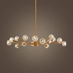 an elegant chandelier with crystal balls hanging from it's brass finish frame