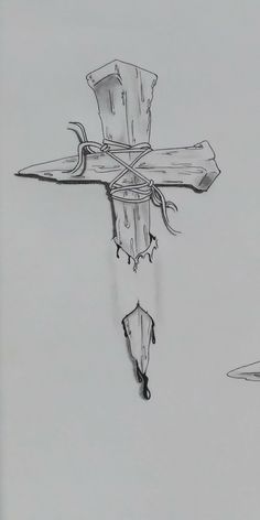 a drawing of a cross on the side of a building with an umbrella hanging from it