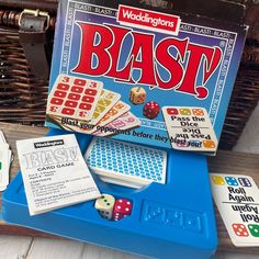 a board game sitting on top of a blue table next to some cards and dice